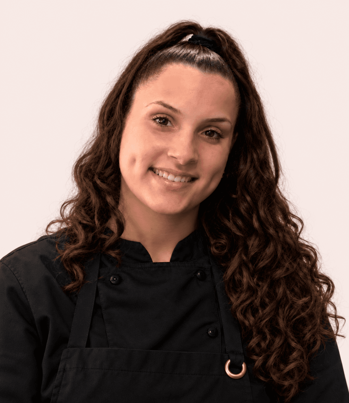 Portrait souriant en veste et tablier de pâtisserie noirs, sur fond clair